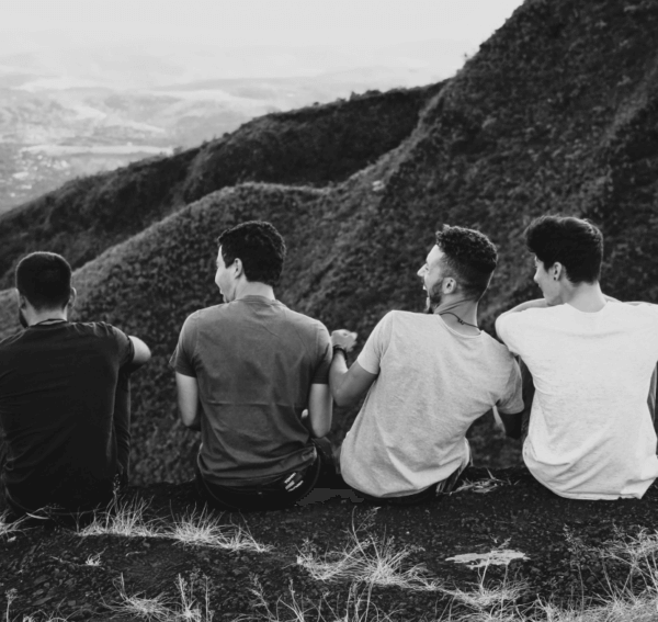 Young men laughing on a mountainside